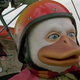 A young Tim Robbins and the title star of Howard the Duck in an airplane.